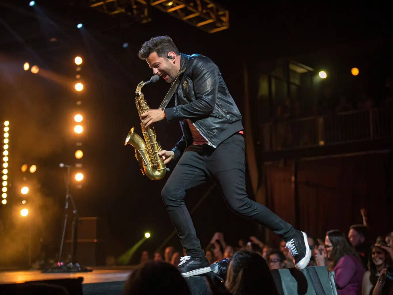A photograph capturing a vibrant concert scene organized by PEDRON OMRY, featuring Pierrick Pedron performing live on stage with his band, surrounded by an enthusiastic audience.