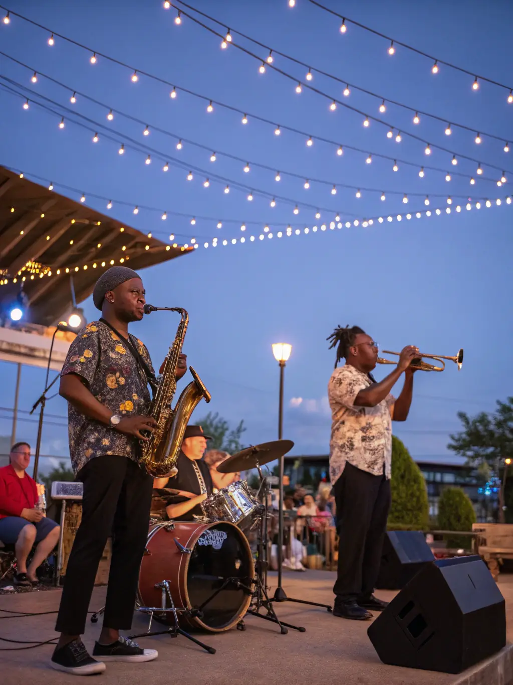 A vibrant photo capturing a diverse audience enjoying a live jazz concert organized by PEDRON OMRY, showcasing community engagement and cultural enrichment.